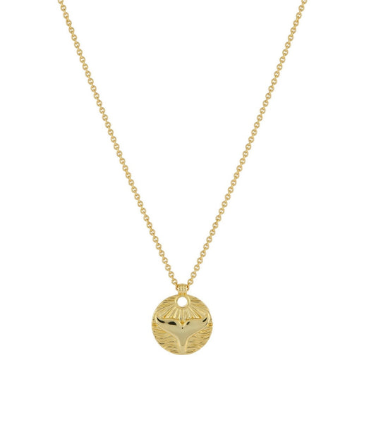 Serene Scenes The Label 18K gold-filled Whale Tale Necklace. Gold chain with circular pendant featuring whale tail against beach horizon design.